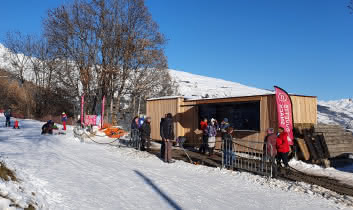 Children with sledges and hot drinks in the refreshment area at the winter activity area at Granier