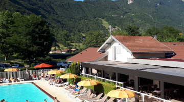 pool deckchairs and restaurant with mountain view