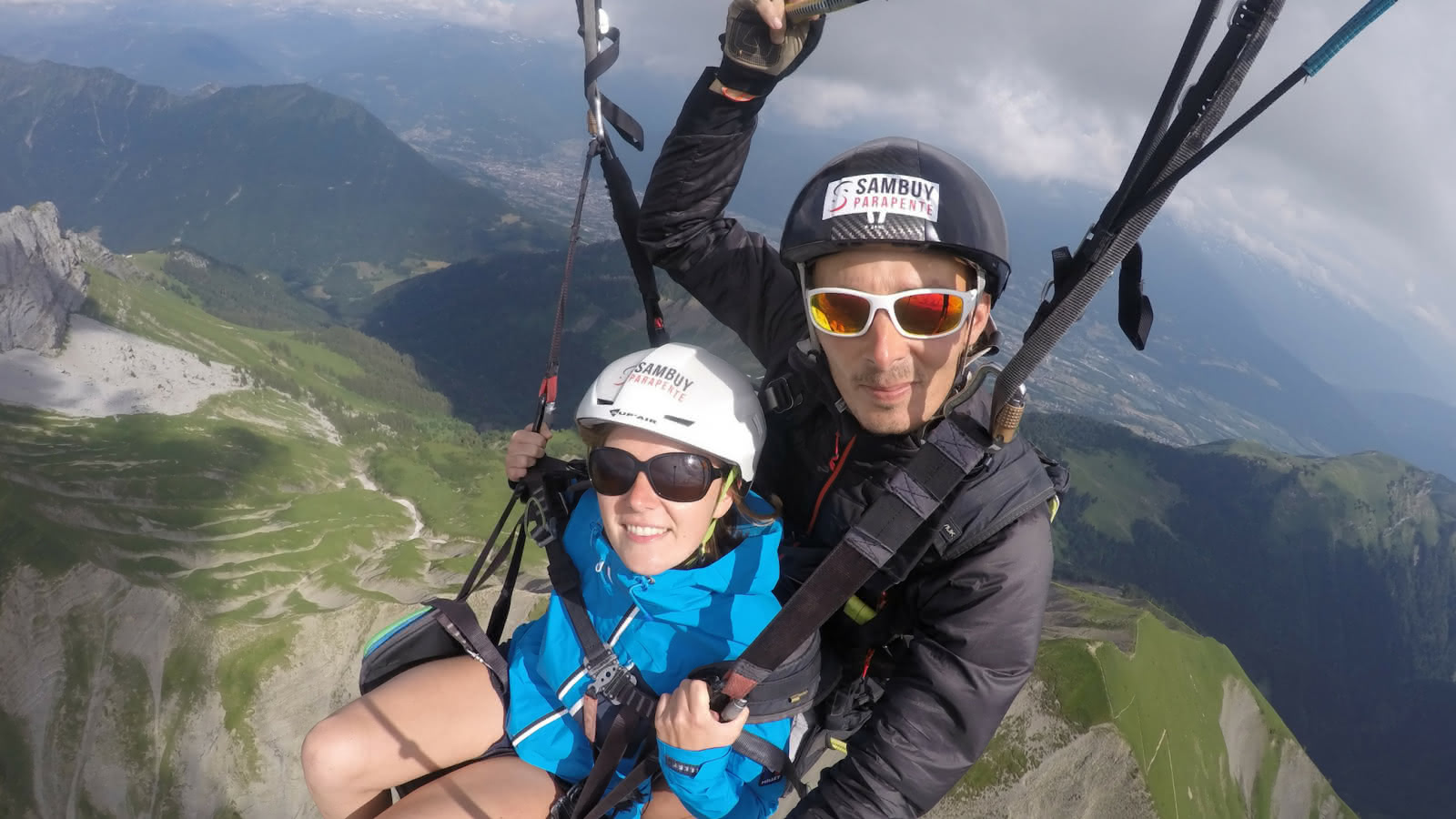 tandem paragliding flight above the mountains